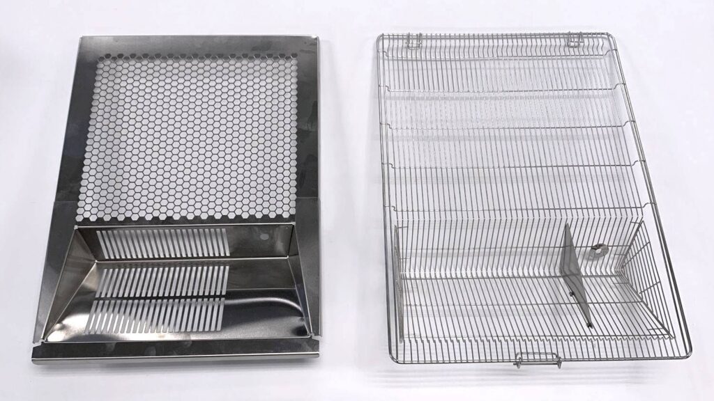 Vision one piece stainless steel lid next to a thin wire lid