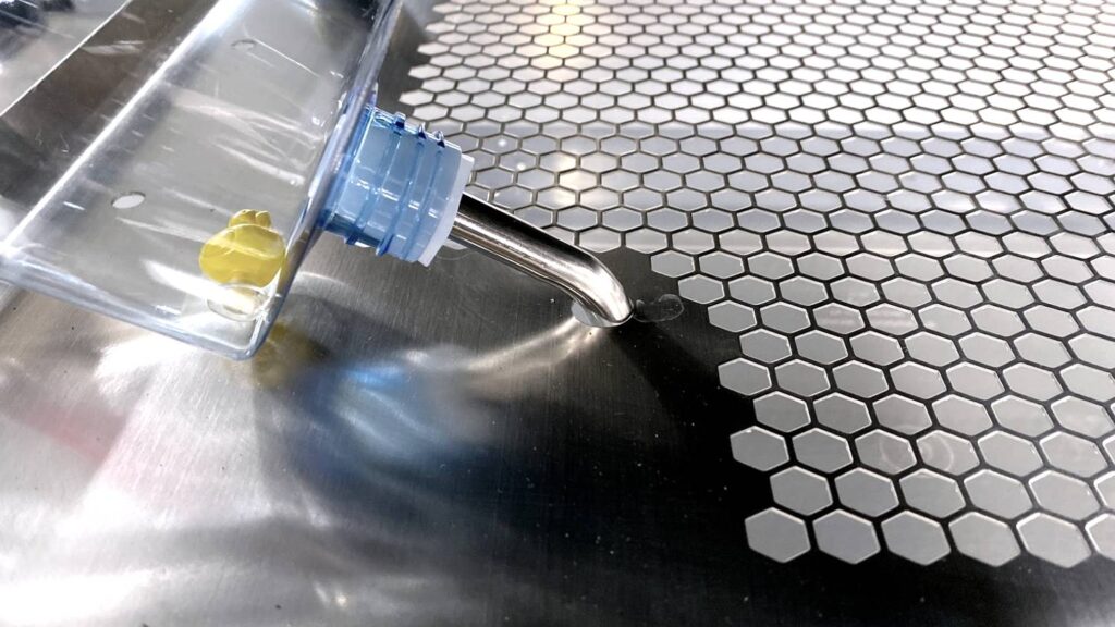 stainless steel shelf equipped with a rodent water bottle and nozzle